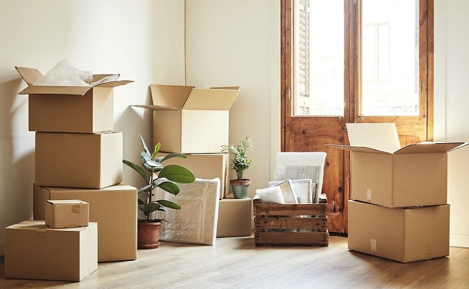 Stacks of cardboard boxes sitting around a door.